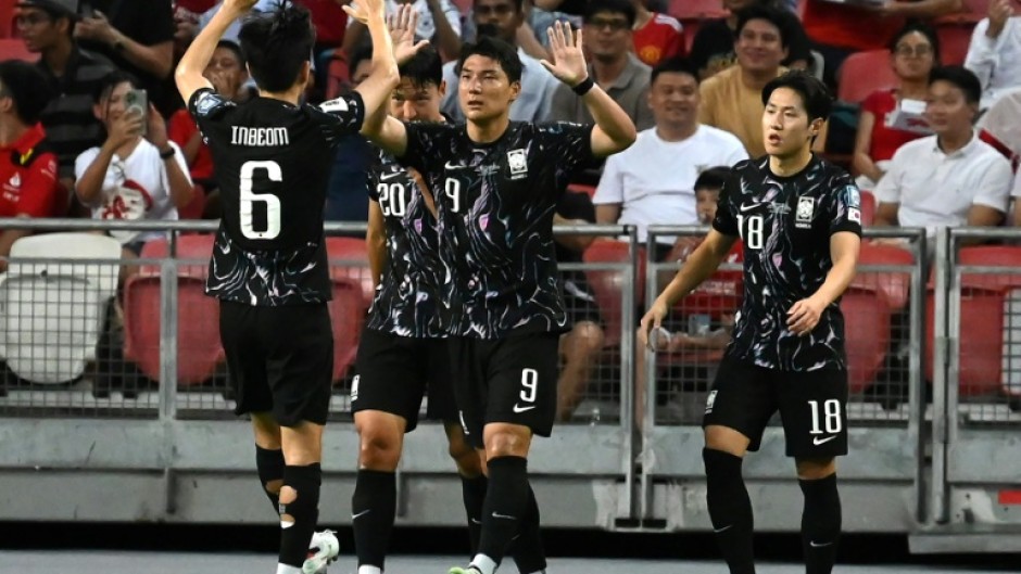 South Korea's Joo Min-kyu (centre) celebrates scoring against Singapore