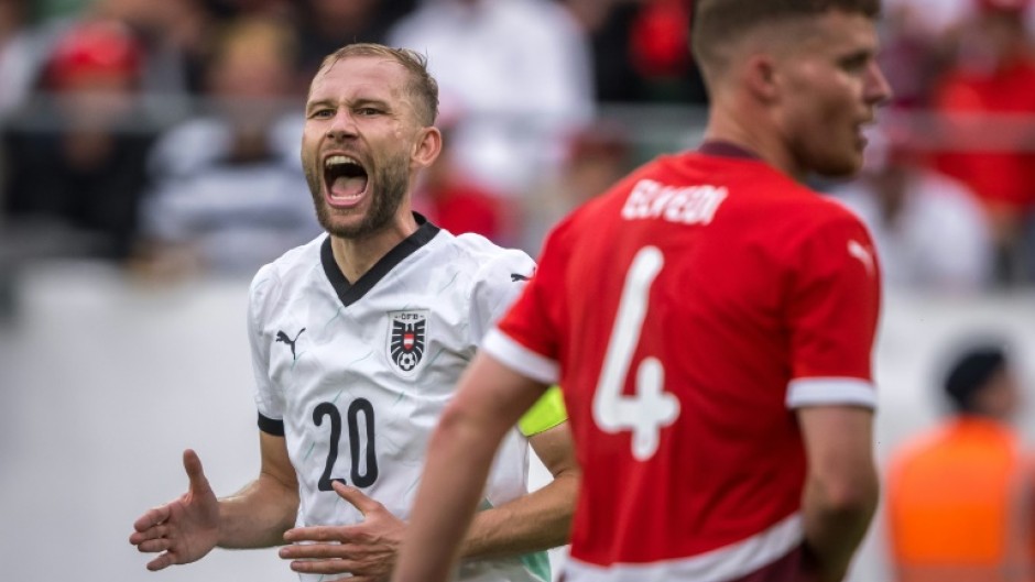 Austria's midfielder Konrad Laimer (L) and Switzerland defender Nico Elvedi featured at the Kybunpark