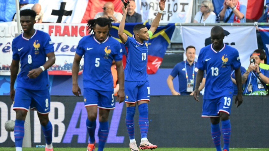 Kylian Mbappe removed his mask to celebrate scoring a penalty to put France ahead but they were frustrated by Poland