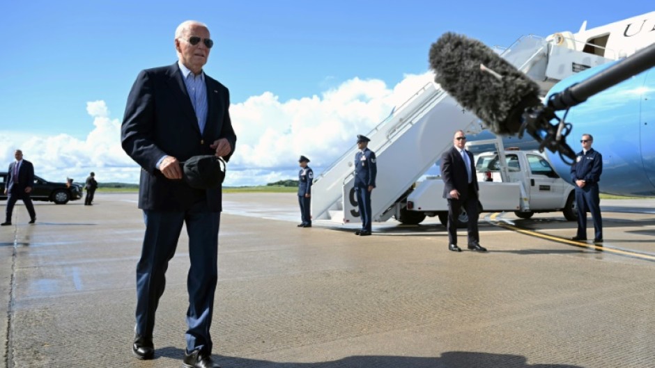 US President Joe Biden walks to speak with the press before boarding Air Force One prior to departure from Dane County Regional Airport in Madison