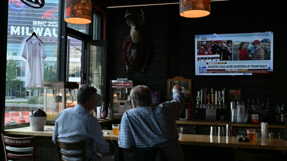 Milwaukee residents watch news of the assassination attempt on Donald Trump at a bar