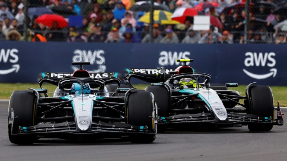Mercedes' drivers Lewis Hamilton and George Russell (L) competing at the Formula One British Grand Prix at Silverstone