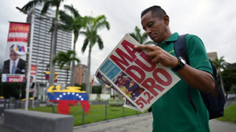 A man reads a newspaper in Caracas on July 29, 2024, a day after the Venezuelan presidential election