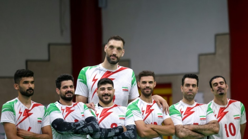 Morteza Mehrzad towers over his teammates in Iran's sitting volleyball team