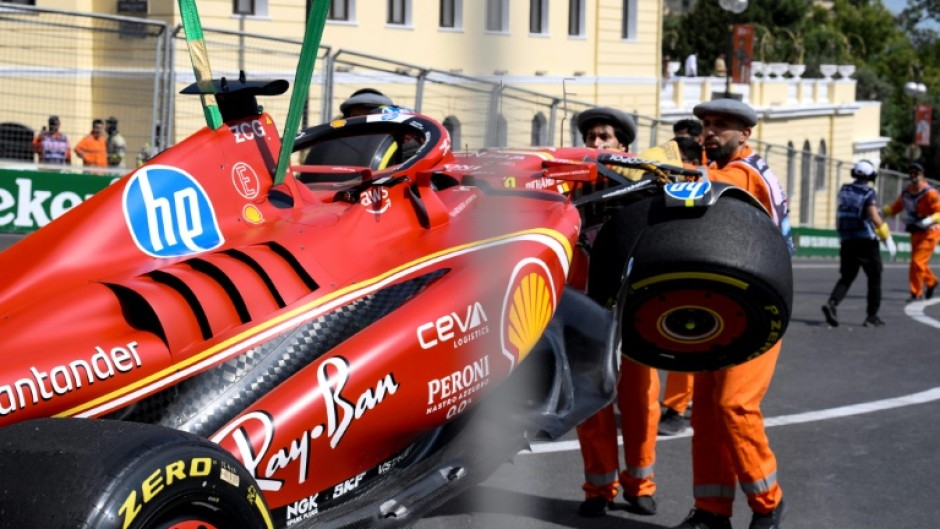 Marshalls remove the damaged Ferrari of Charles Leclerc following a crash during the first practice session for the Azerbaijan Grand Prix