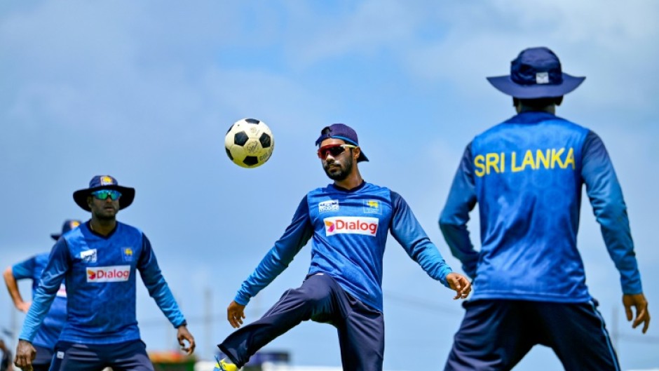 Sri Lanka's captain Dhananjaya De Silva (C) plays football during a practice session ahead of the first Test against New Zealand
