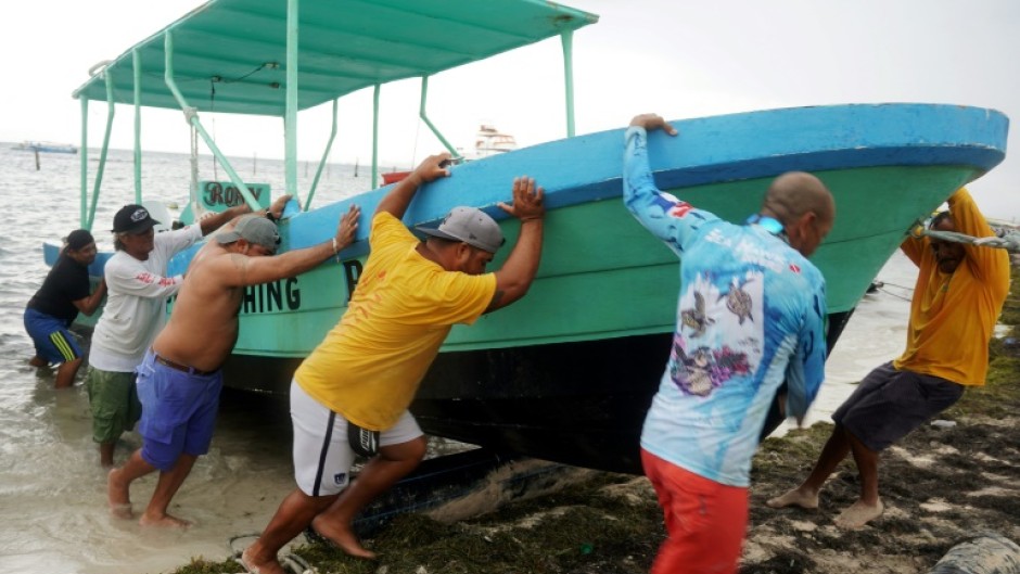 People secure their boats ahead of the arrival of Hurricane Helene in Cancun, Quintana Roo state, Mexico 
