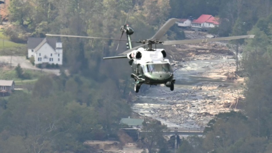 Marine One, carrying US President Joe Biden, flies above a storm impacted area near Asheville, North Carolina