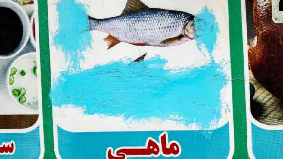 Images of living things, including a fish at a restaurant in Lashkar Gah in Helmand province, are often censored in Afghanistan since the Taliban takeover 
