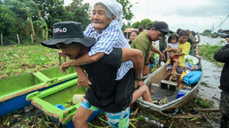 In Bato municipality, residents waited for rescuers as the floodwaters left only the roofs of houses visible