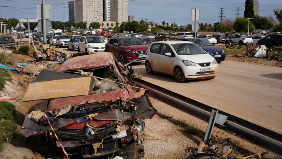 Wreckage of cars on the side of a road on October 31, 2024 after flash floods affected Paiporta, in Valencia