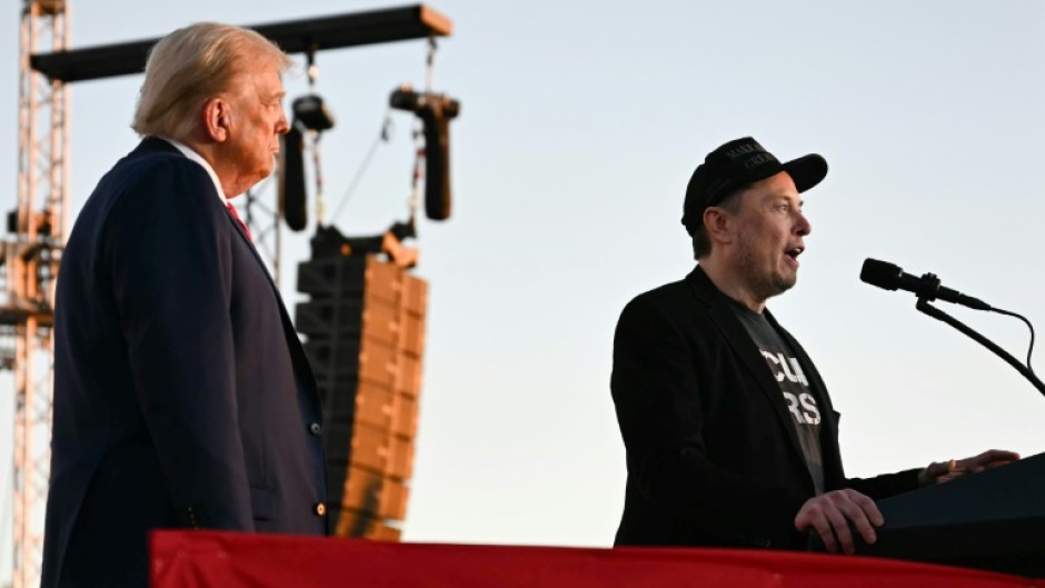 Elon Musk speaks on stage as he joins Donald Trump during a campaign rally