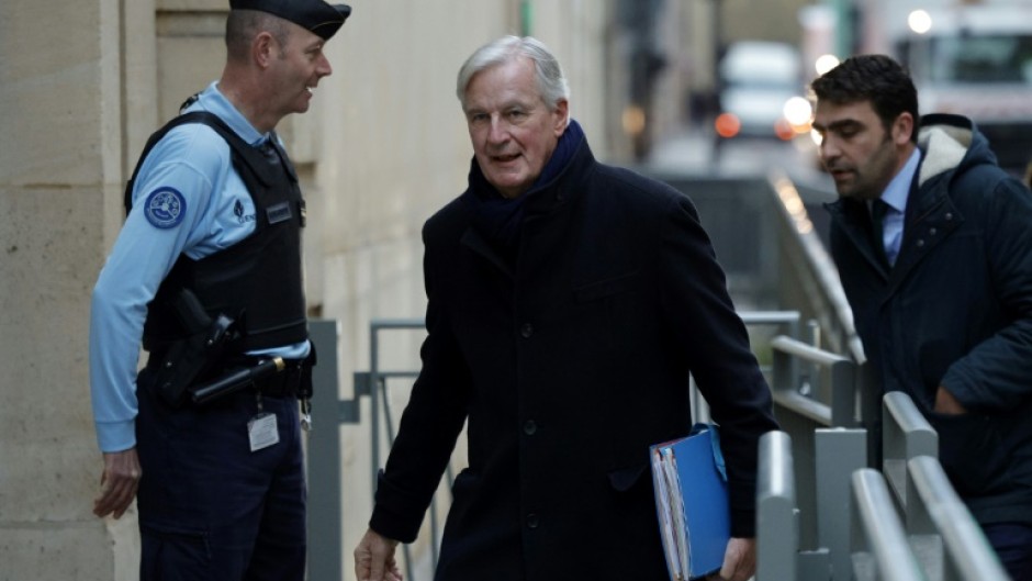 Michel Barnier (C) has been back at work since Monday after his weekend operation