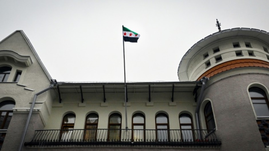 The flag of Syria's opposition waves over the country's embassy in Russia, a key ally of Assad
