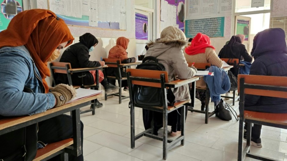 Afghan students take a test at an institute of health sciences in Ghazni