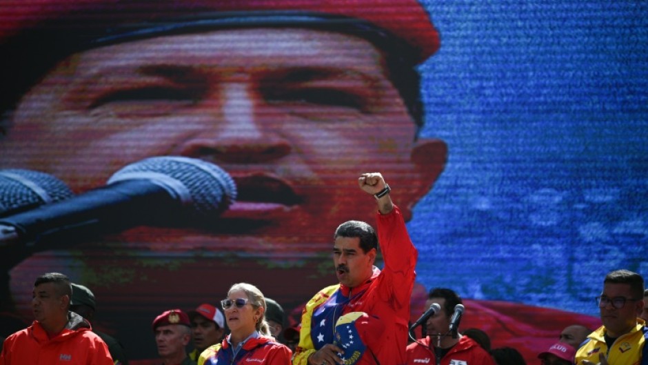 Nicolas Maduro was thrust into power as the handpicked successor of Hugo Chavez (on screen) who died of cancer in 2013 but is still hailed as a revolutionary hero by many