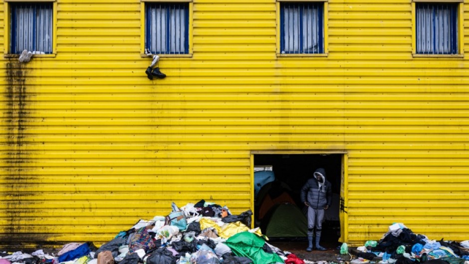 Hundreds of migrants are living in an abandoned warehouse on the outskirts of the port city of Calais