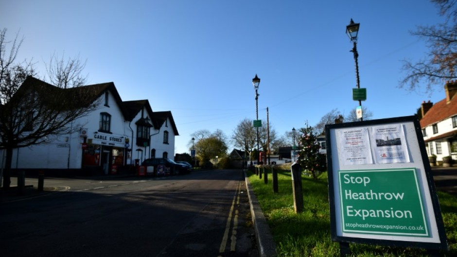 Signs reading "Stop Heathrow Expansion" dot the village of Harmondsworth