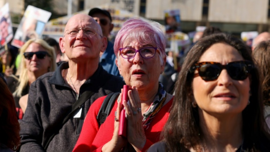 Israelis in Tel Aviv watch live television coverage of the latest hostage release.