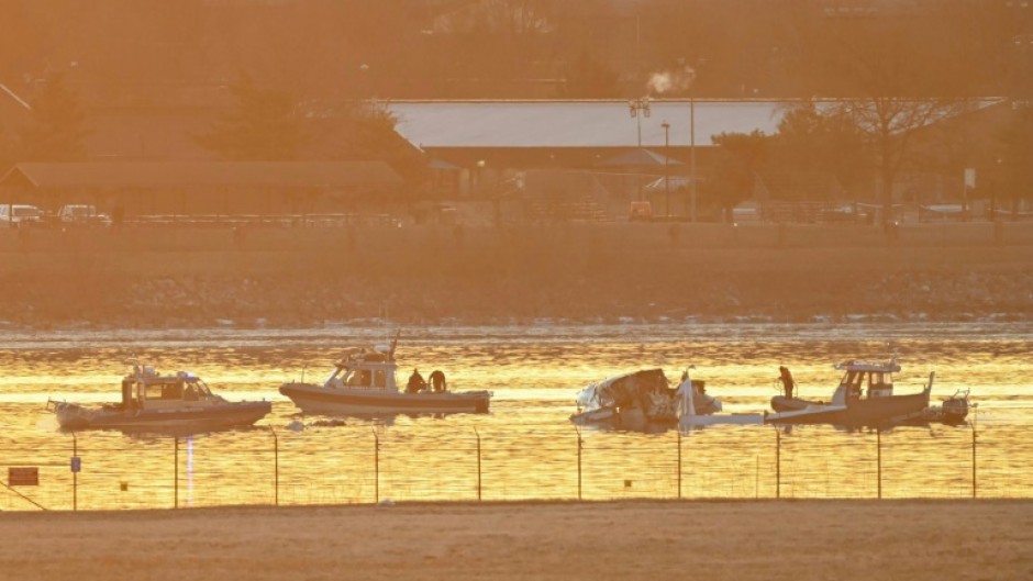 Rescuers on boats search the waters of the Potomac River after a plane carrying several elite figure skaters crashed near Washington's Reagan National Airport 