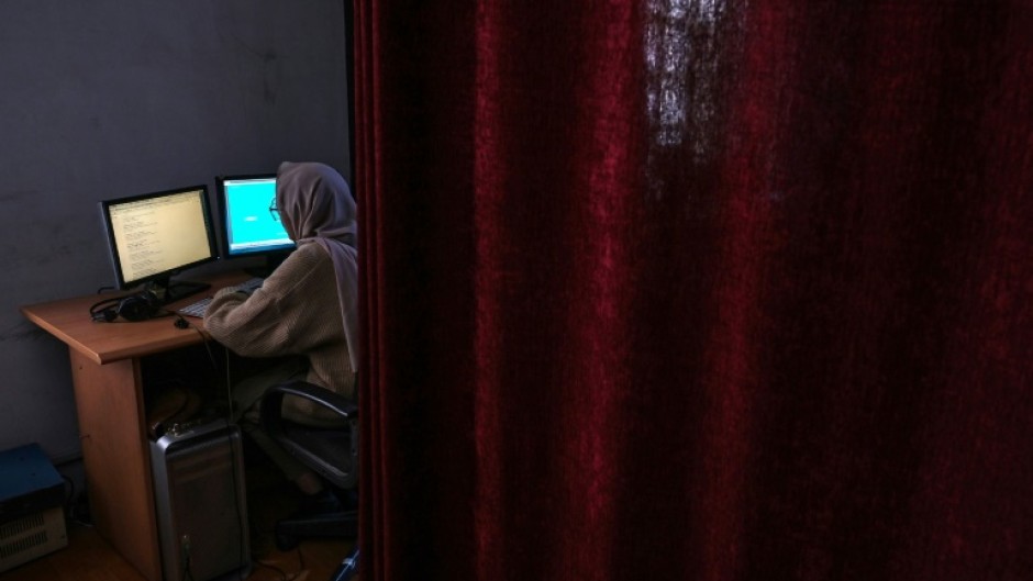 A woman is seen in November 2021 working at Kabul's Radio Begum, a women's radio station that has been raided by Afghanistan's Taliban authorities