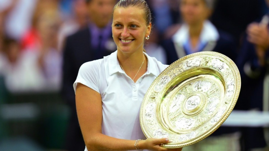Czech Republic's Petra Kvitova holds the Wimbledon winner's trophy in 2014