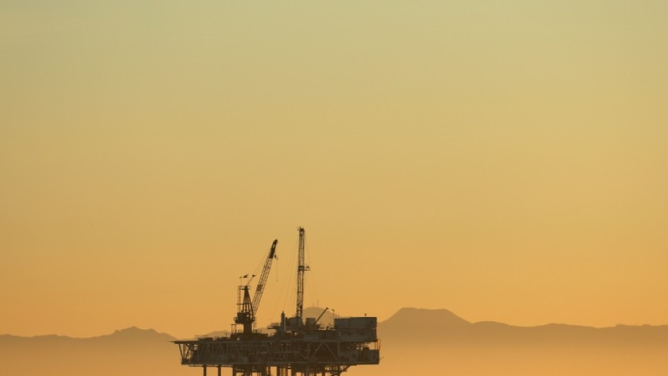 A gull flies with offshore oil and gas platform Esther in the distance on January 5, 2025 in Seal Beach, California; President Donald Trump is seeking to un-ban a prohibition on offshore oil drilling put in place by his predecessor Joe Biden