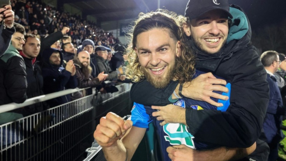 Shock victory: Stade Briochin's Leo Yobe celebrates with a fan