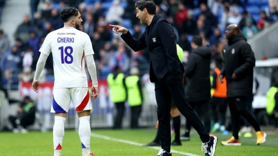 New Lyon coach Paulo Fonseca (R) speaks with Rayan Cherki during the 4-0 win over Reims in Ligue 1 on Sunday