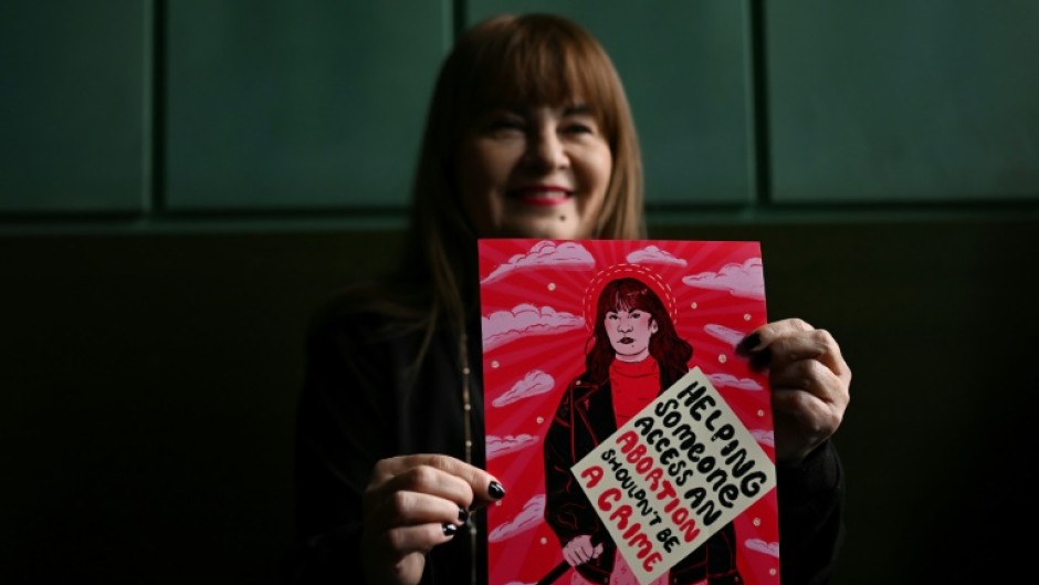 Polish pro-choice activist Justyna Wydrzynska shows a postcard from her supporters prior to her verdict announcement at the appeals court.