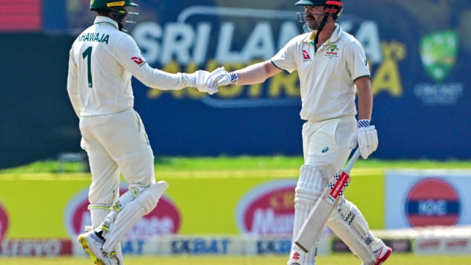 Australia's Usman Khawaja (left) and teammate Travis Head bump fists on the fourth day of the second Test against Sri Lanka in Galle