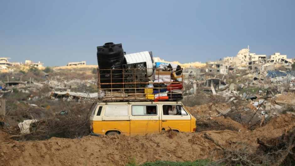 Displaced Palestinians cross the Netzarim Corridor as they make their way to the northern parts of the Gaza Strip