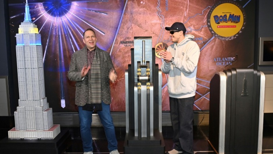 Pete Davidson (R) who voices the titular character in the animated movie 'Dog Man,'  visits The Empire State Building with Dav Pilkey to celebrate the film's premier