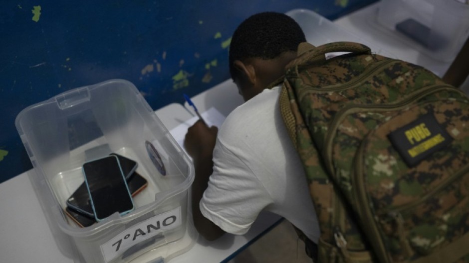 A student leaves his cellphone at the beginning of the school day at Reverend Martin Luther King public school in Rio de Janeiro