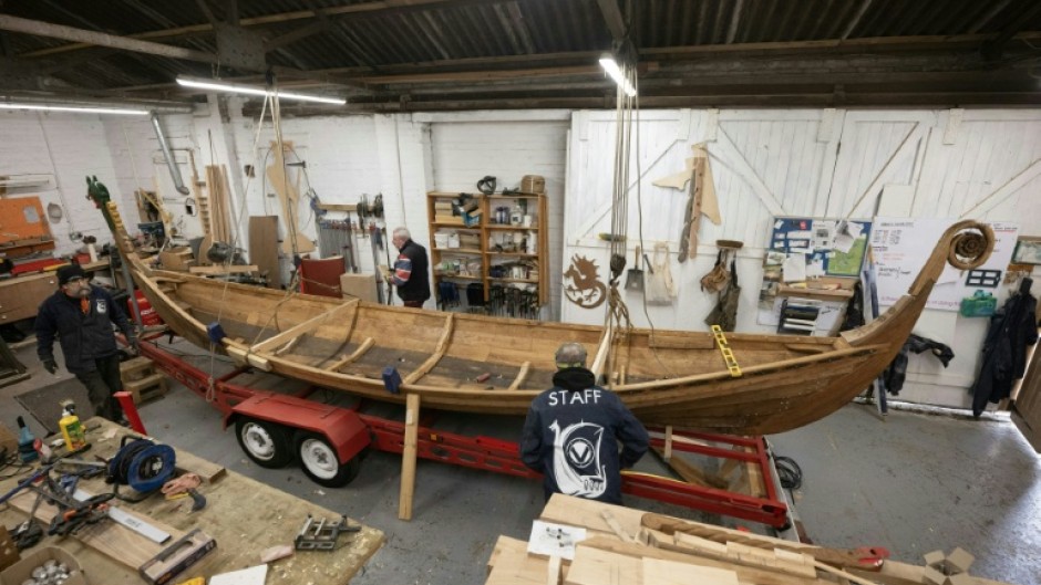 Veterans put the finishing touches to a Viking longboat built from solid oak using authentic Scandinavian plans as part of a project to help restore their mental health 