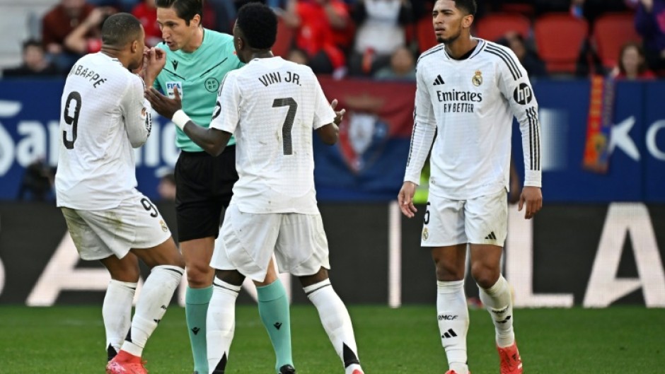 Flashpoint: Real Madrid's Kylian Mbappe and Vinicius Junior remonstrate with referee Jose Munuera over the red card given to Jude Bellingham (R)