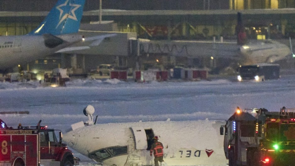 A Delta plane on its roof after crashing on landing at Toronto Pearson Airport