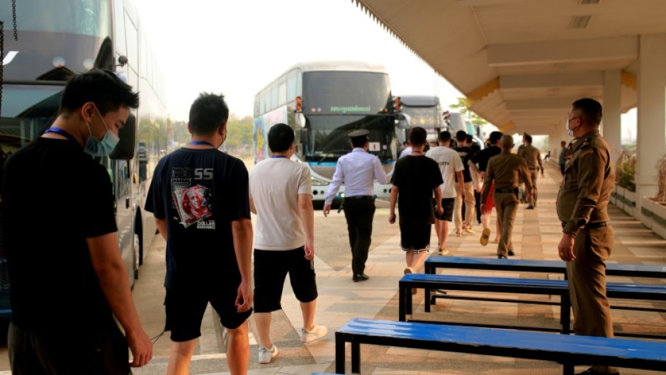Alleged scam centre workers and victims from China arrive at the border checkpoint with Thailand in Myanmar's eastern Myawaddy township on February 20
