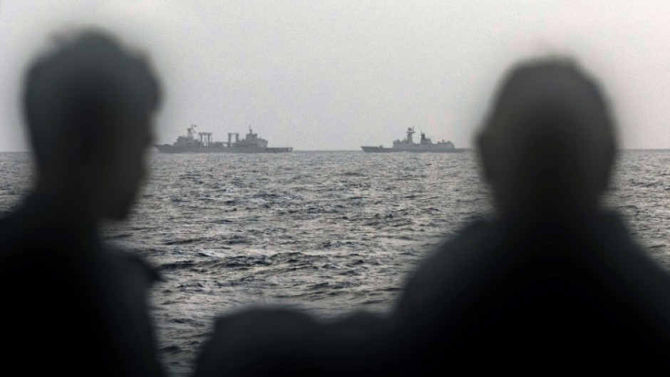 Sailors aboard an Australian navy ship look out at Chinese vessels on February 13, picture by the Australian Defence Force