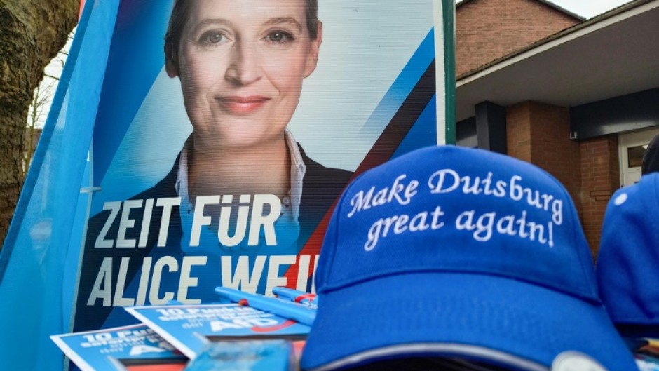 A poster of the Alternative for Germany's Alice Weidel and a 'Make Duisburg Great Again' cap at a stall of the far-rigth party in the western industrial town
