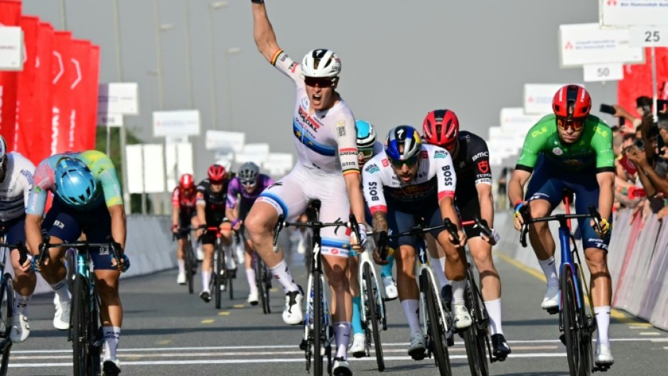 Tim Merlier raises his fist to celebrate a stage victory after two near misses in  the UAE Tour