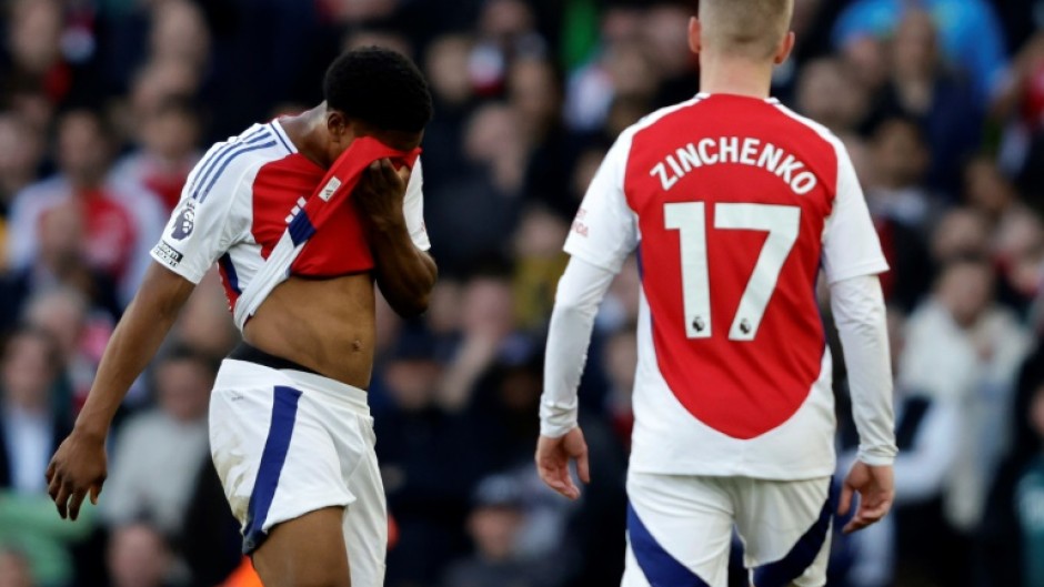 Arsenal's Myles Lewis-Skelly (L) reacts after being sent off against West Ham