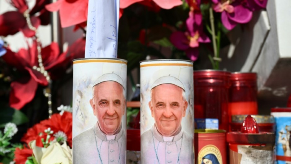 A hand written message is placed in a candle of Pope Francis outside the Gemelli hospital 