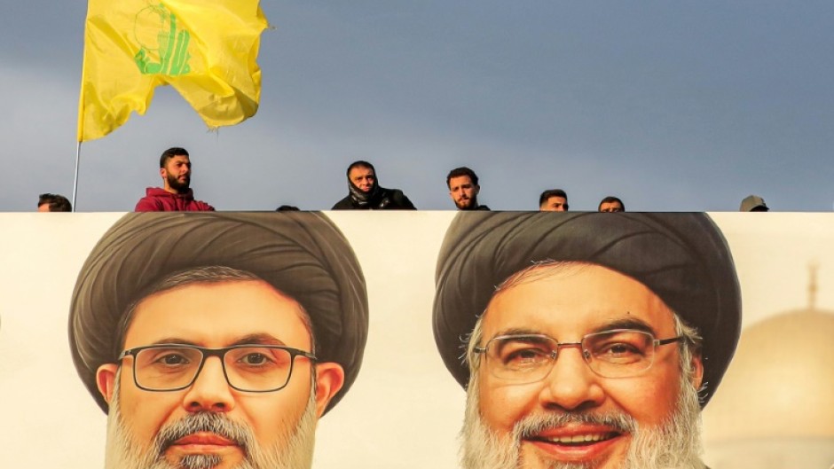 A giant portait of slain Hezbollah leader Hassan Nasrallah (R) and his chosen successor Hashem Safieddine -- also slain -- is placed over Beirut's airport highway ahead of their funeral