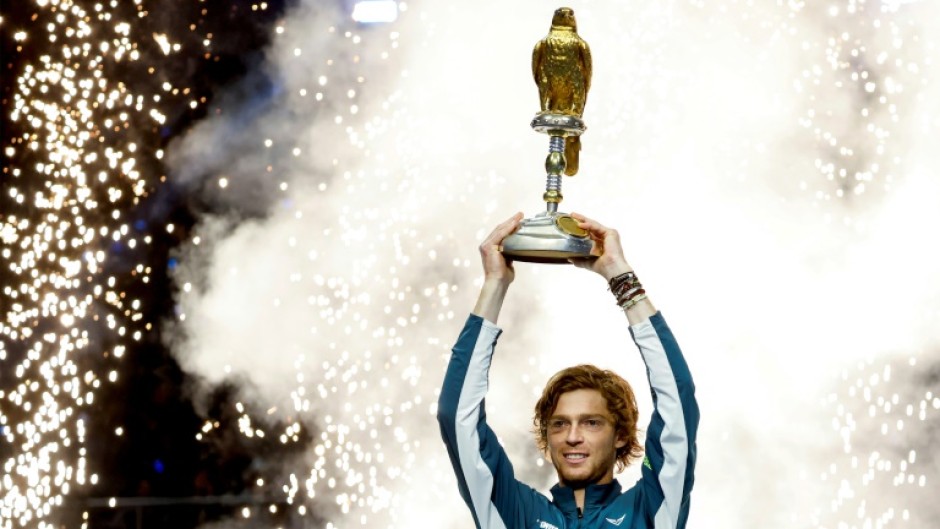 Andrey Rublev brandishes the trophy  after winning the Qatar Open