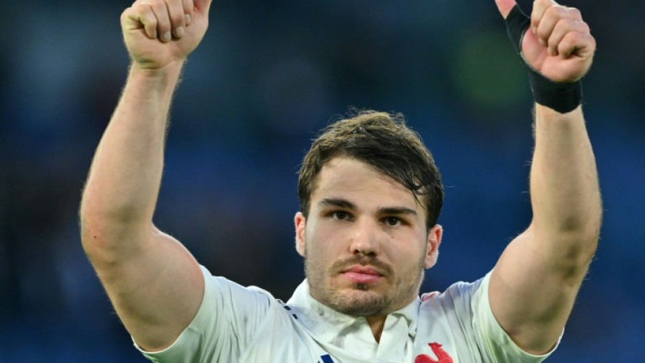 Twice as good: France scrum-half Antoine Dupont, who scored two tries, celebrates victory in Italy