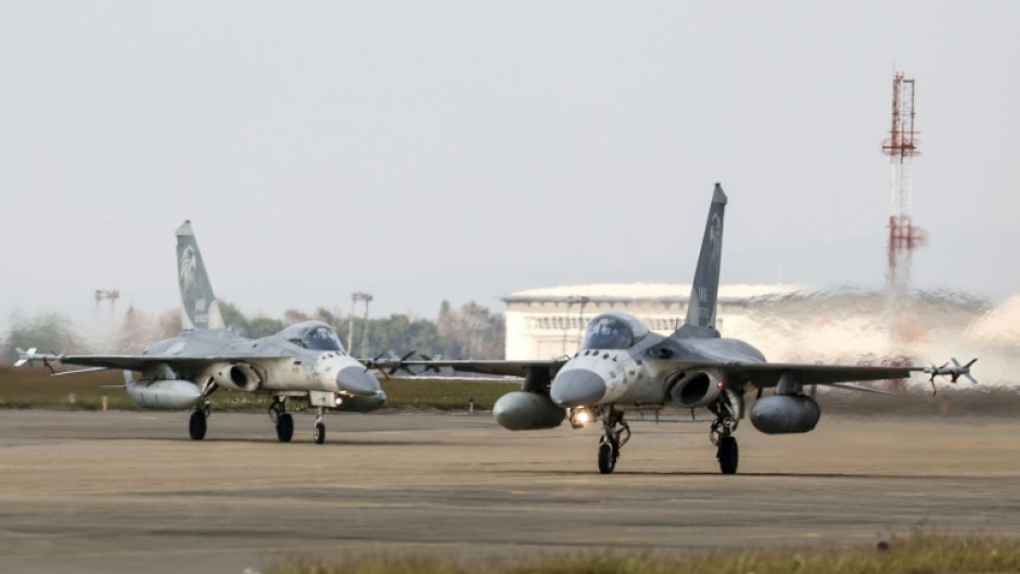 Taiwanese air force Indigenous Defense Fighter aircraft taxi for take-off during a scramble as part of a combat readiness exercise at an air base in Taichung in January