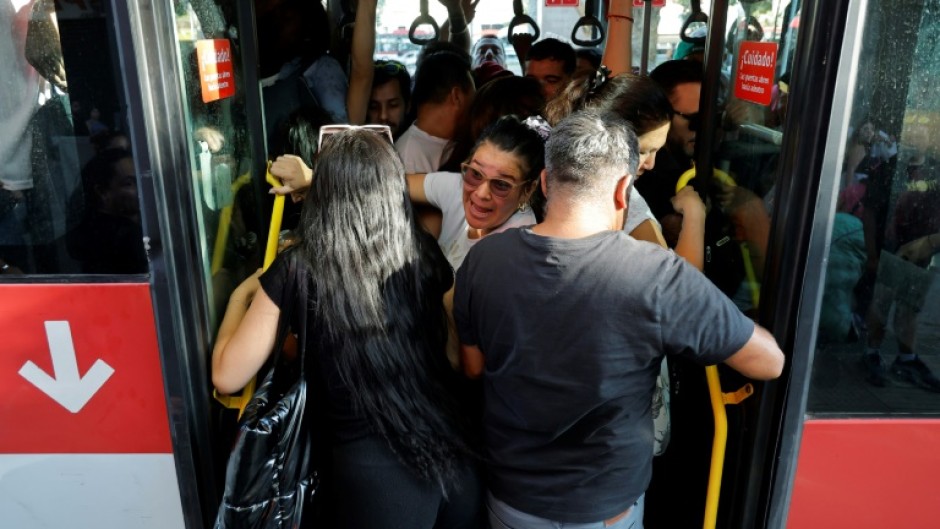 People crowd inside a bus during a Chile's worst blackout in well over a decade