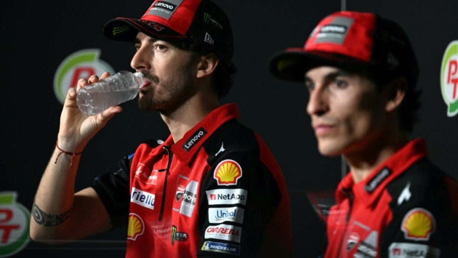 Francesco Bagnaia (L) and  Marc Marquez take part in a press conference in Thailand