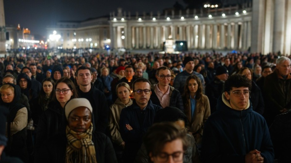 People gather to pray for the health of Pope Francis at St Peter's square 